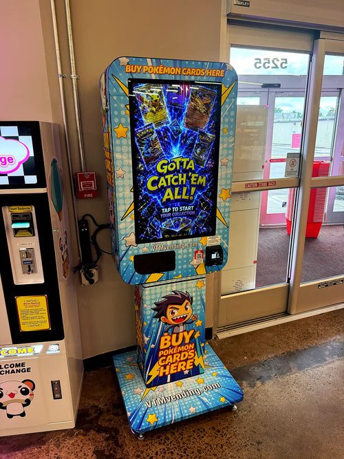 Colorful Pokémon card vending machine positioned beside a glass entrance with a touchscreen and card reader.